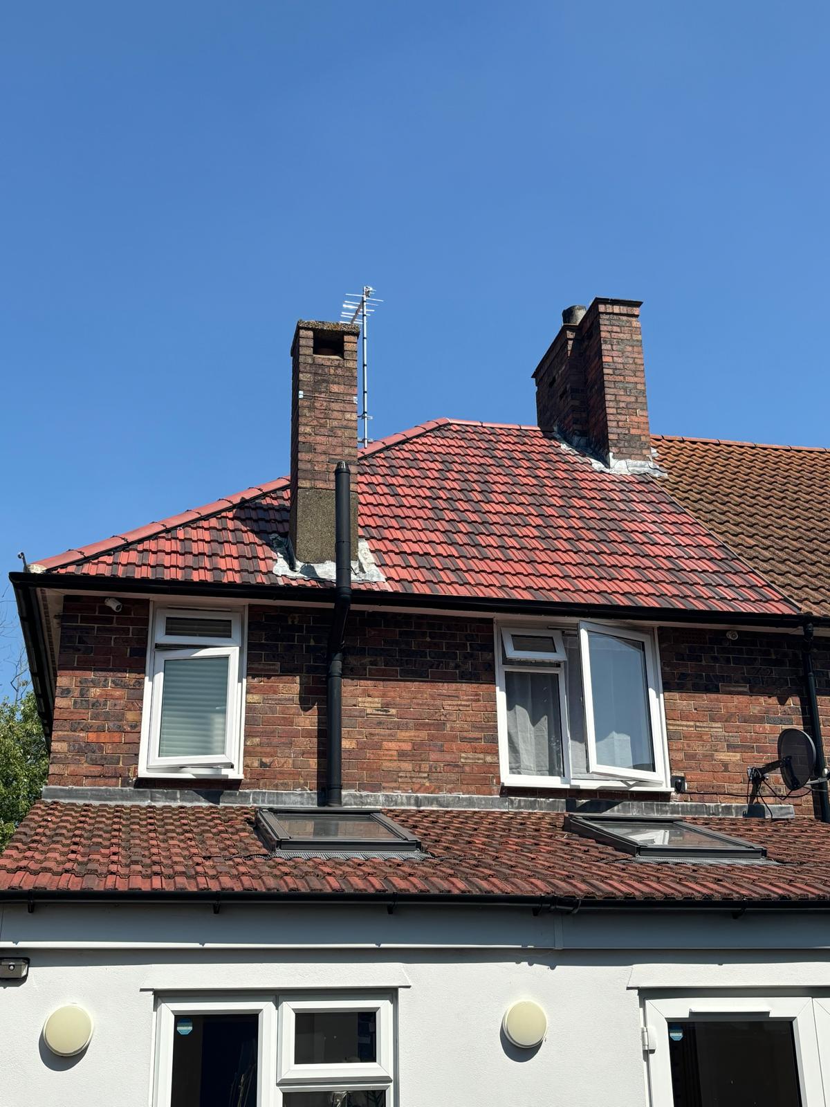 Completed re-roof with new red clay tiles and chimney weatherings