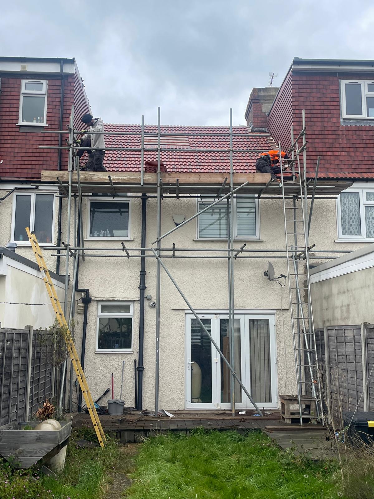 Full re-roof in progress with scaffold at first-floor level