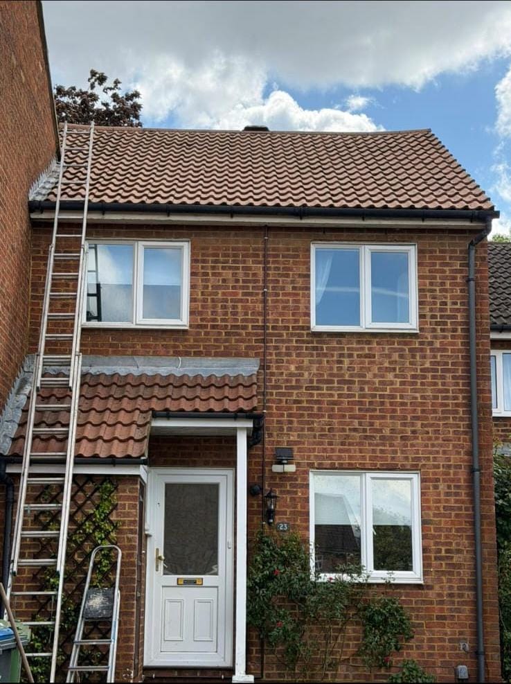 Completed re-roof with new concrete tiles and black round-line gutter
