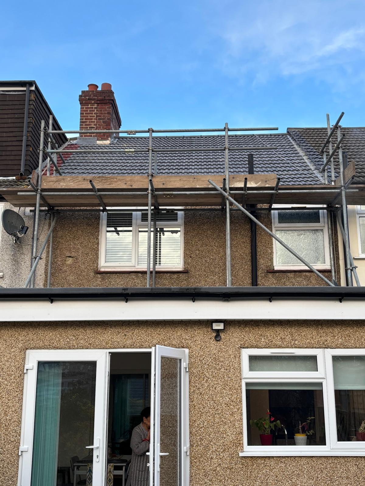 New tiled roof with scaffold in place, ready for final ridge
