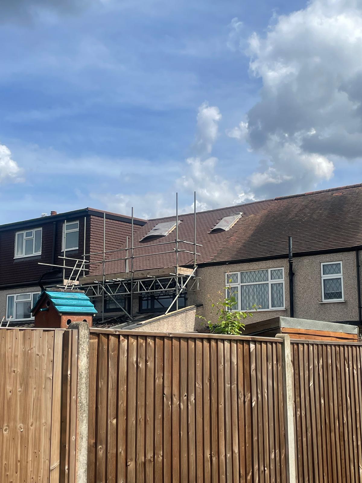 Two Velux windows fitted mid re-roof, viewed from the rear garden