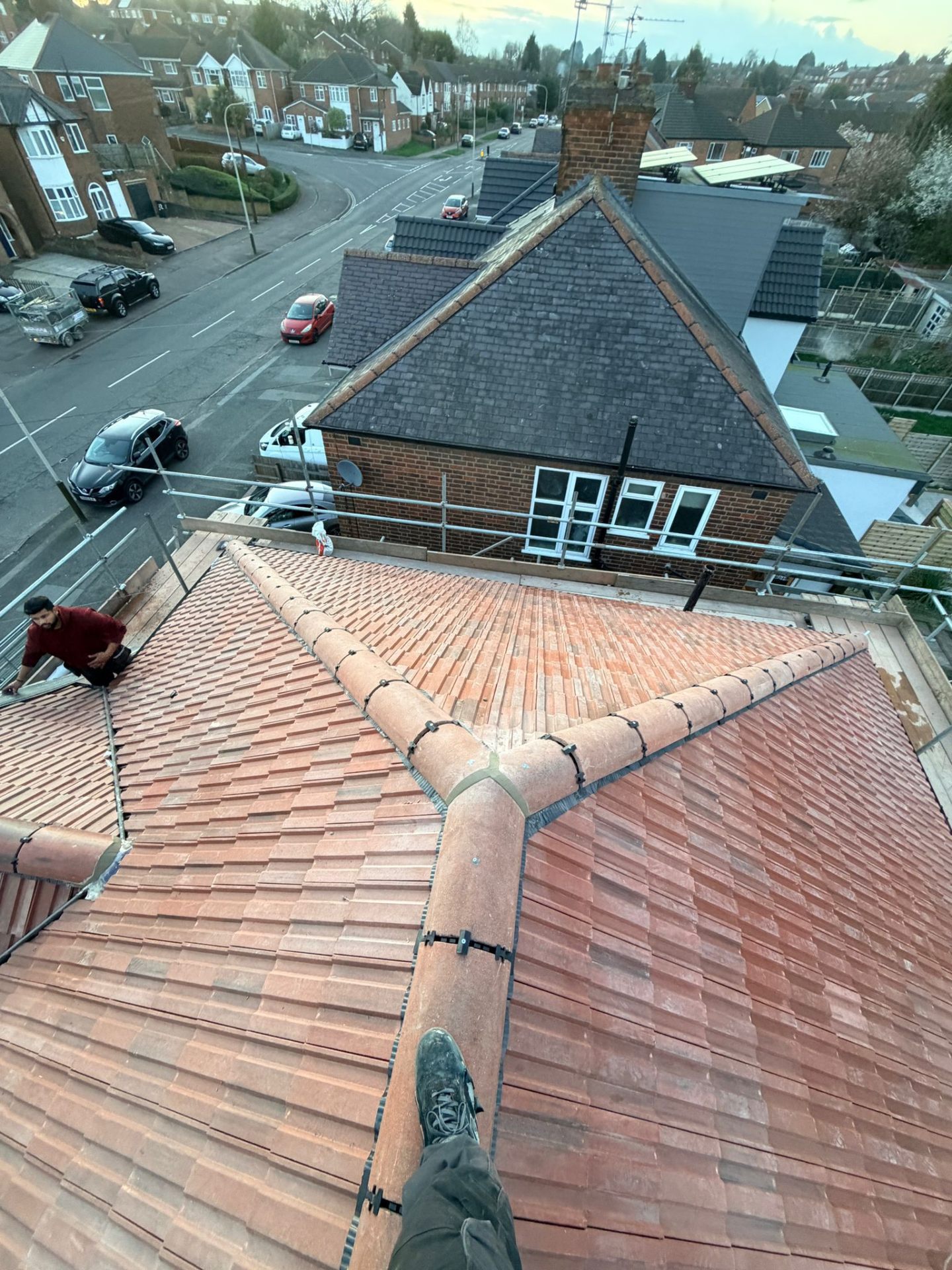 New clay tile hipped roof installation — rooftop view
