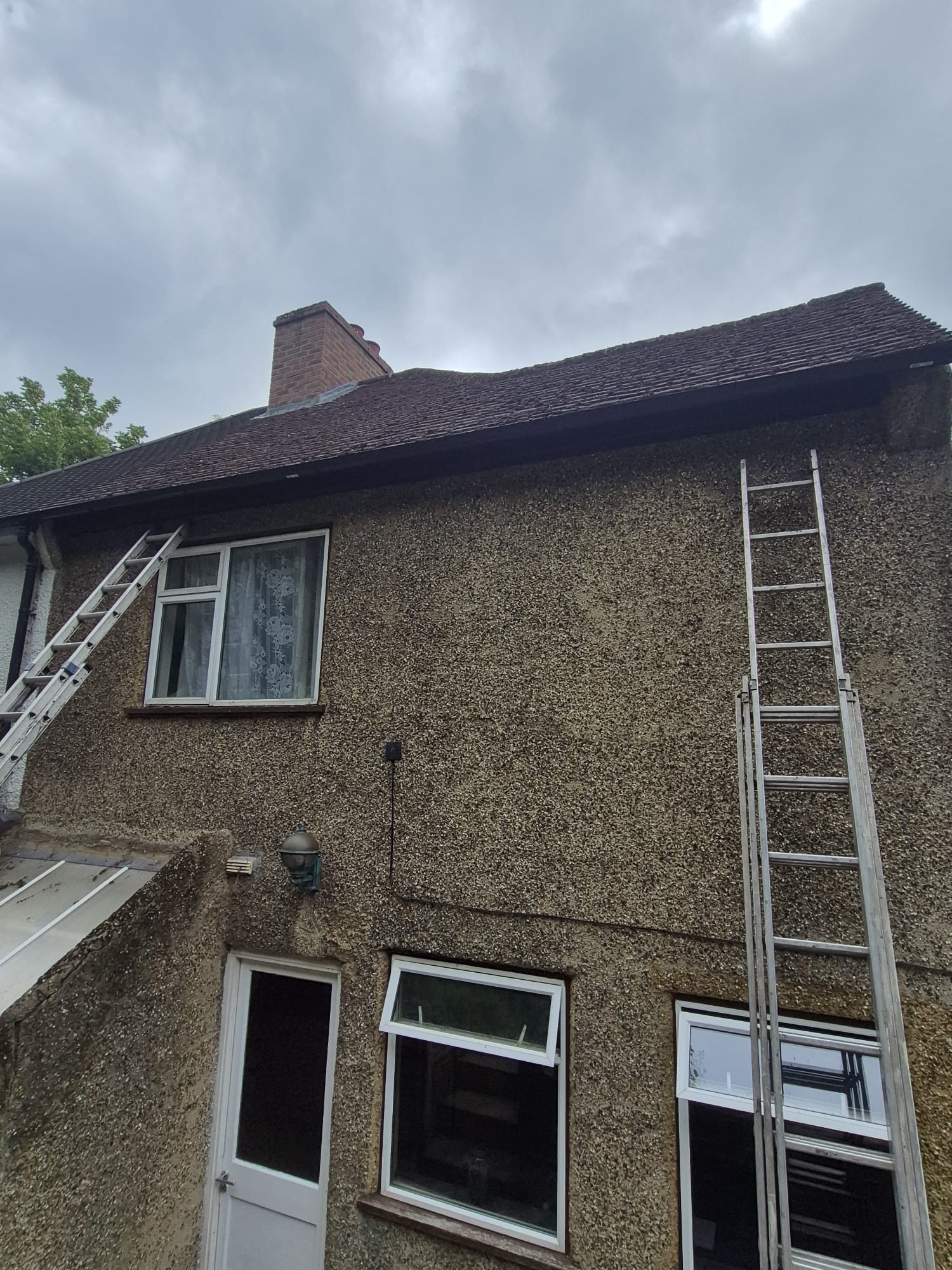 Roof survey before re-roof — moss covered tiles