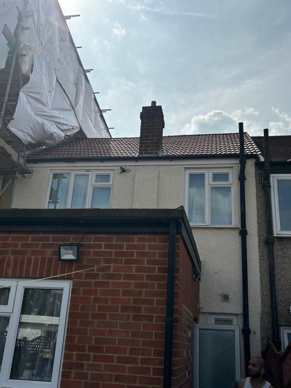 New concrete tile roof with chimney weathering — scaffold in view