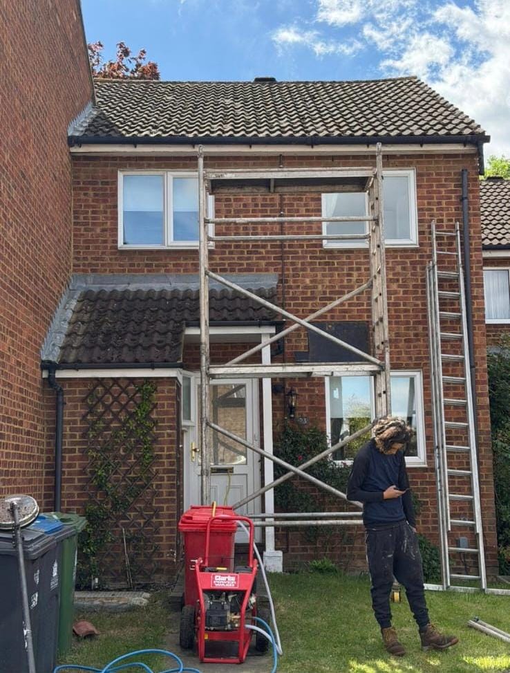 Roof cleaning setup with scaffold tower and pressure washer